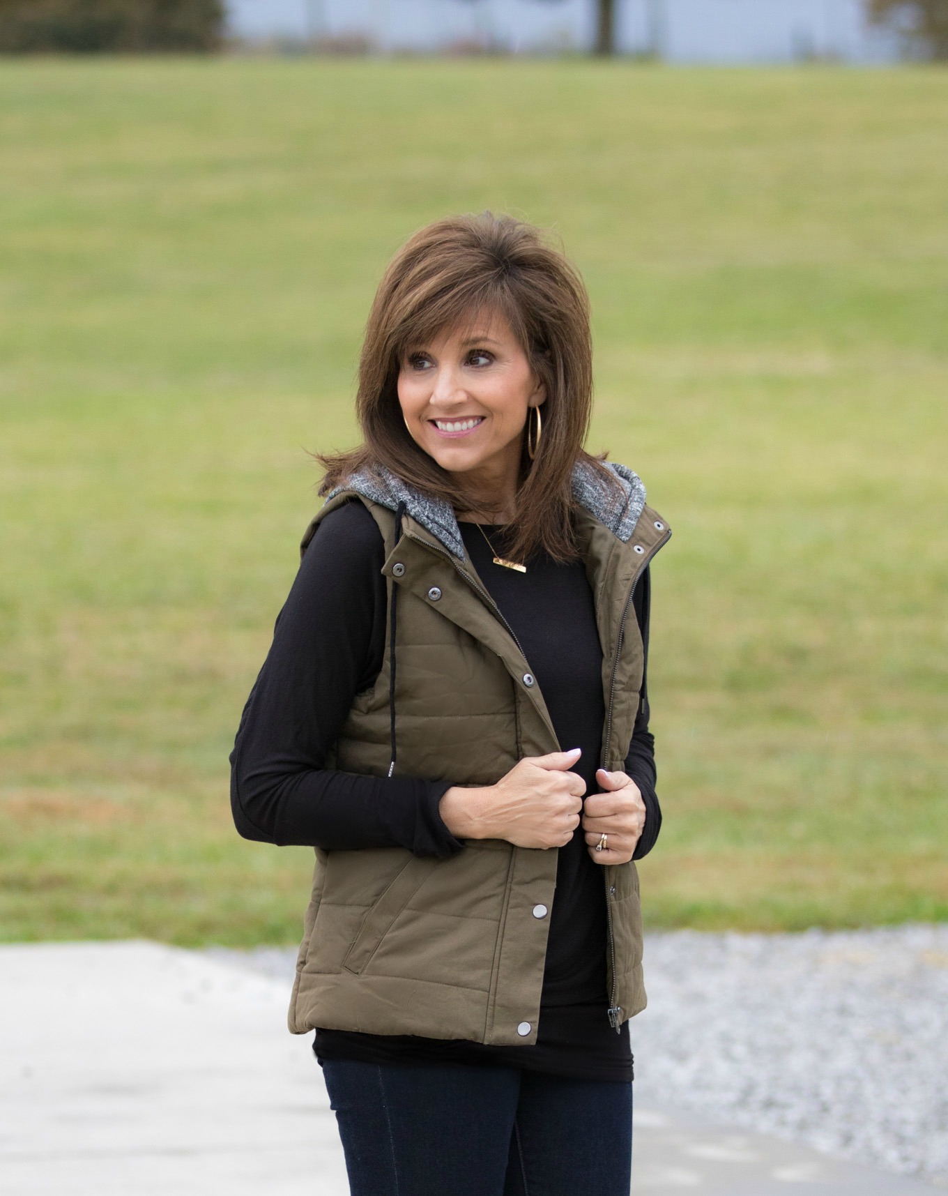 Fashion blogger, Cyndi Spivey, styling a hooded vest for fall.
