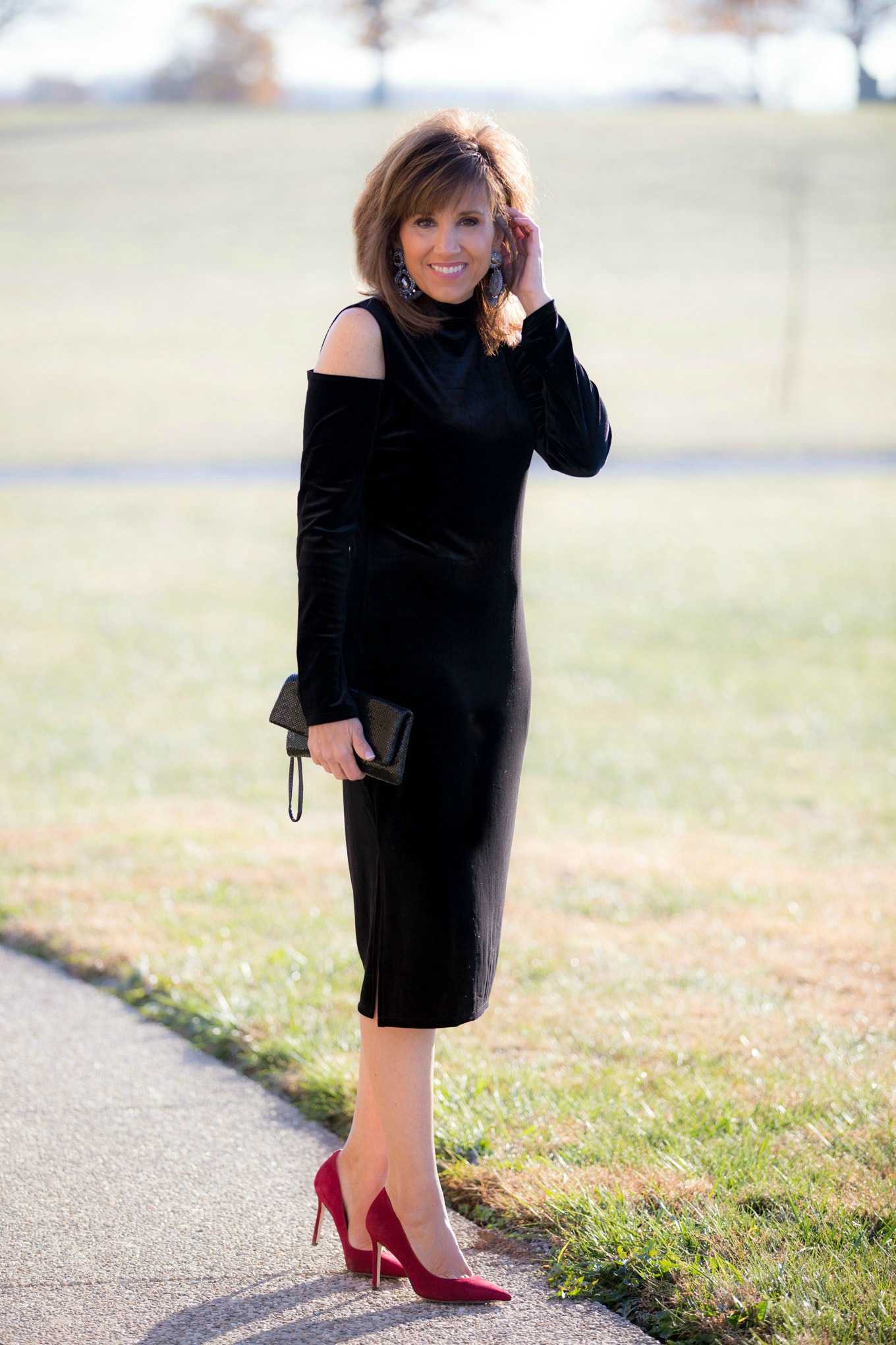 Fashion blogger, Cyndi Spivey, styling a cut out shoulder dress from Nordstrom for holiday style.