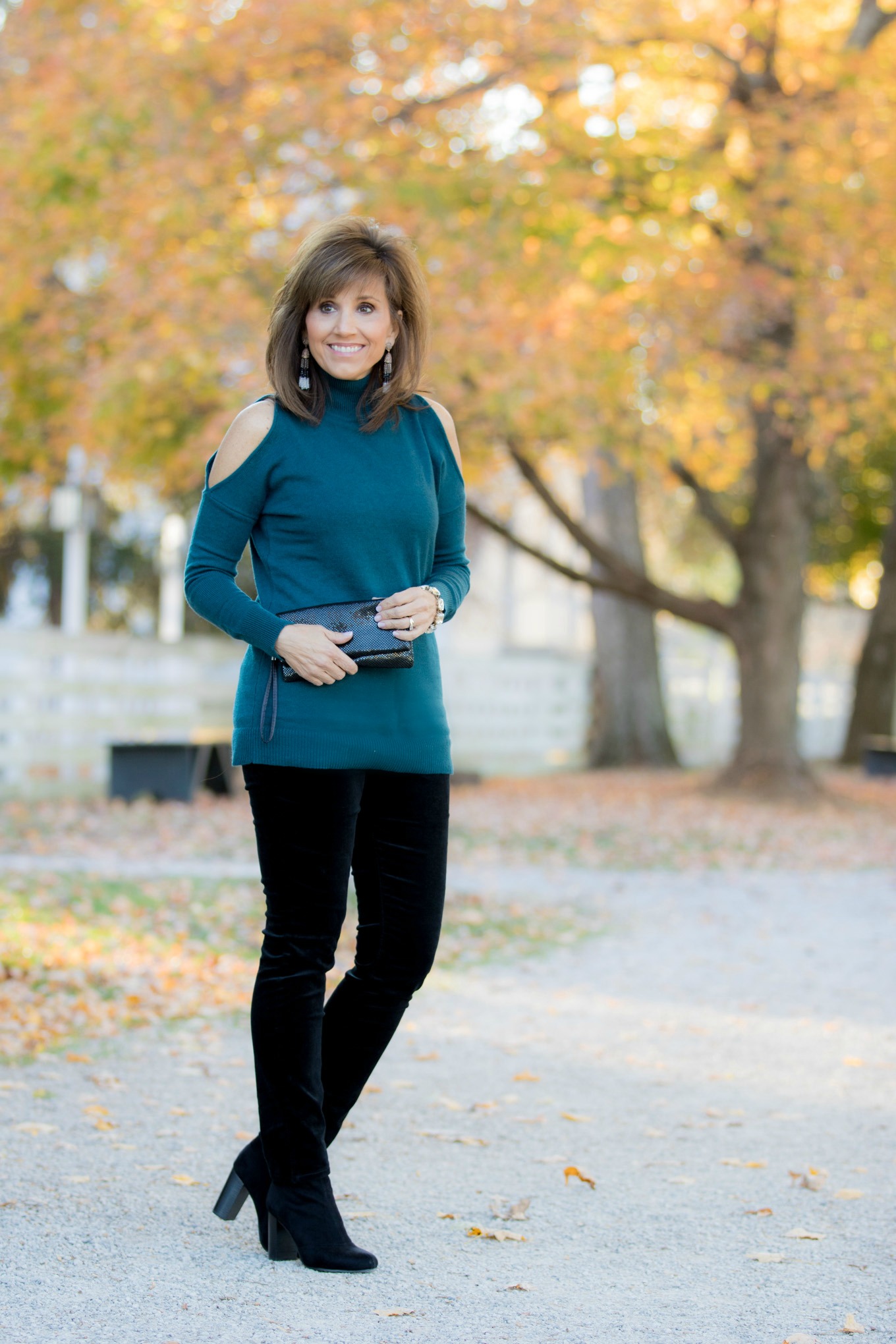 Fashion blogger, Cyndi Spivey, sharing a cold shoulder turtleneck with velvet pants.