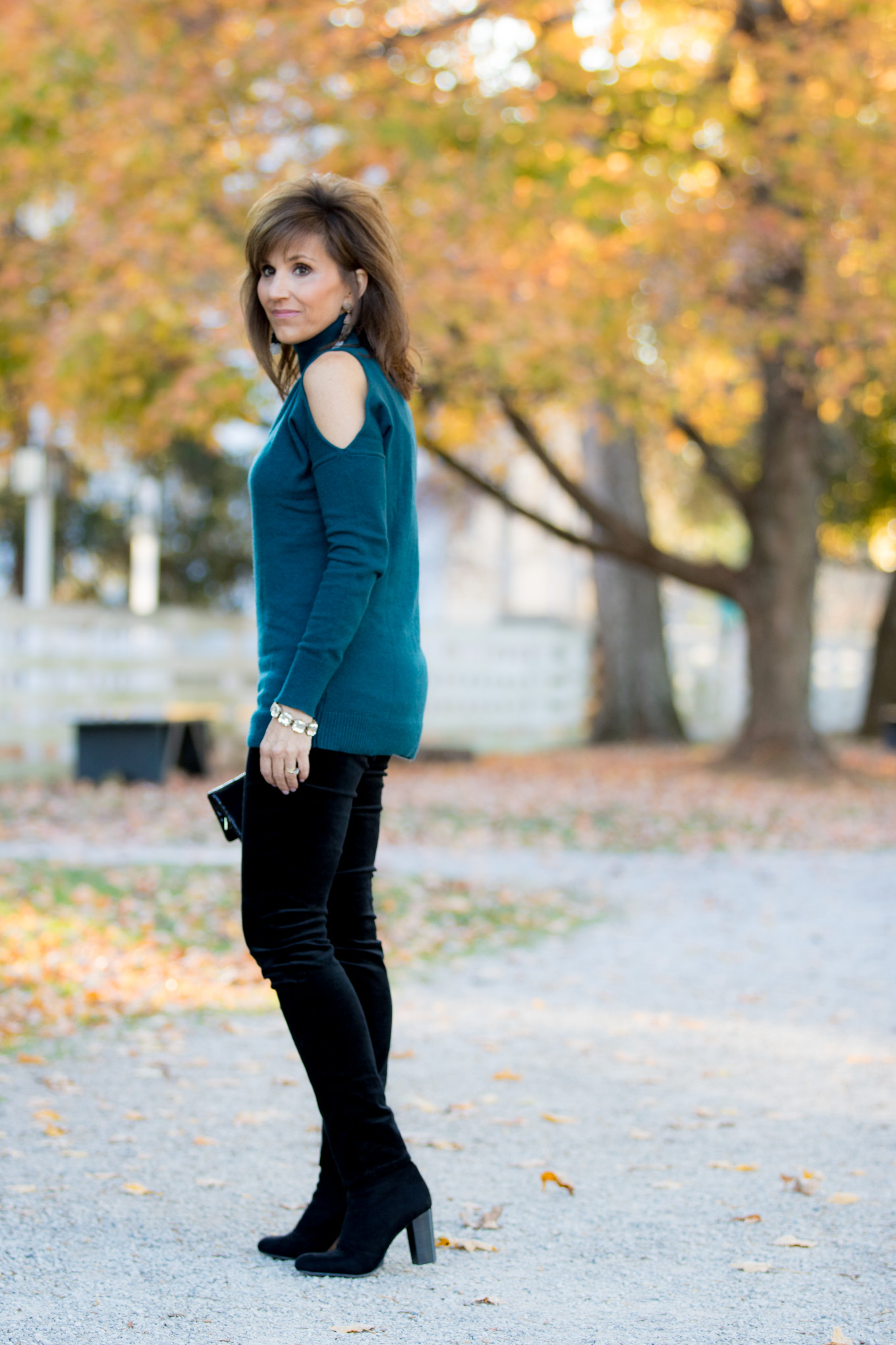 Fashion blogger, Cyndi Spivey, sharing a cold shoulder turtleneck with velvet pants.