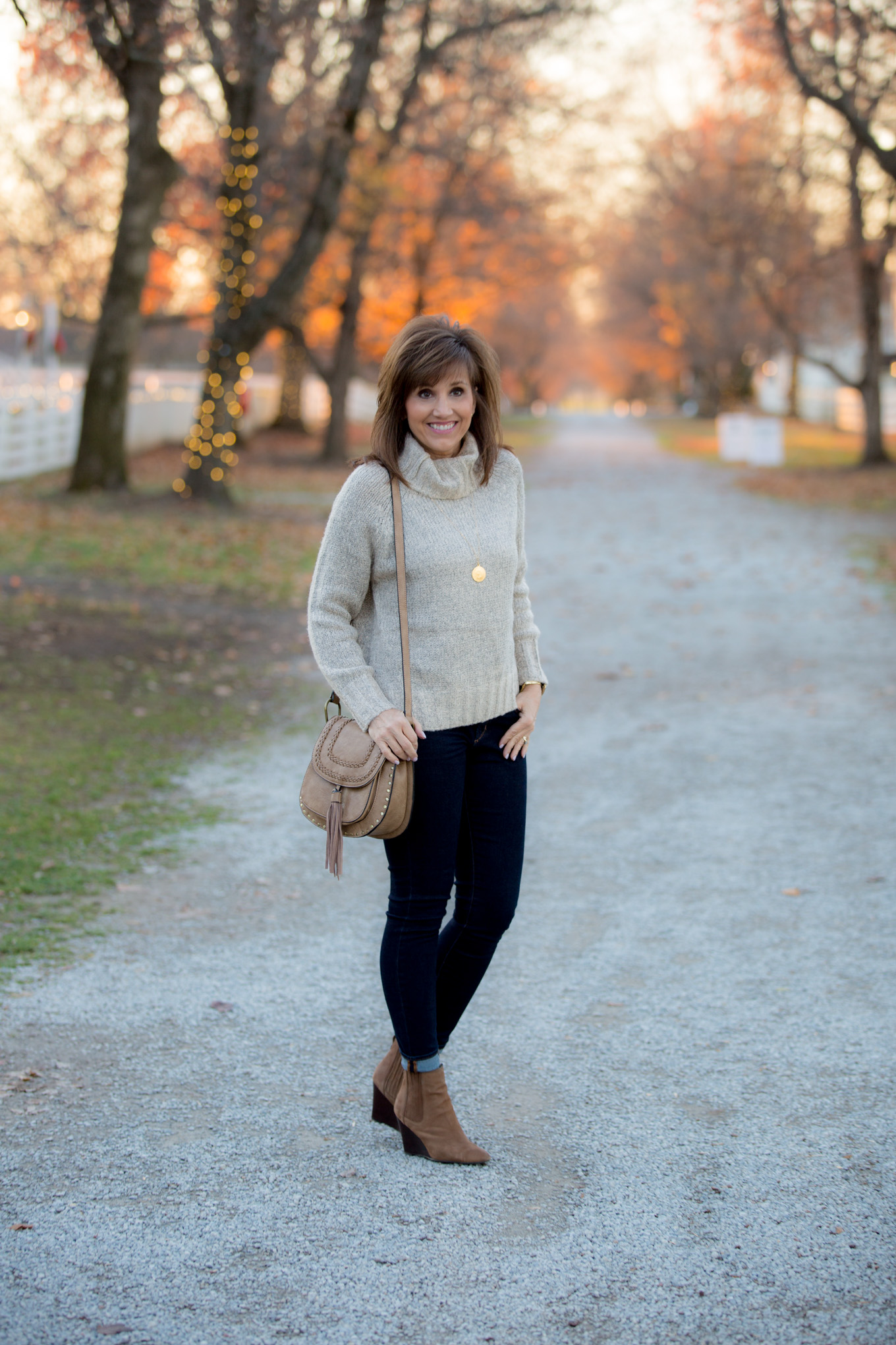 Fashion blogger, Cyndi Spivey, styling a cozy turtleneck sweater for winter fashion.